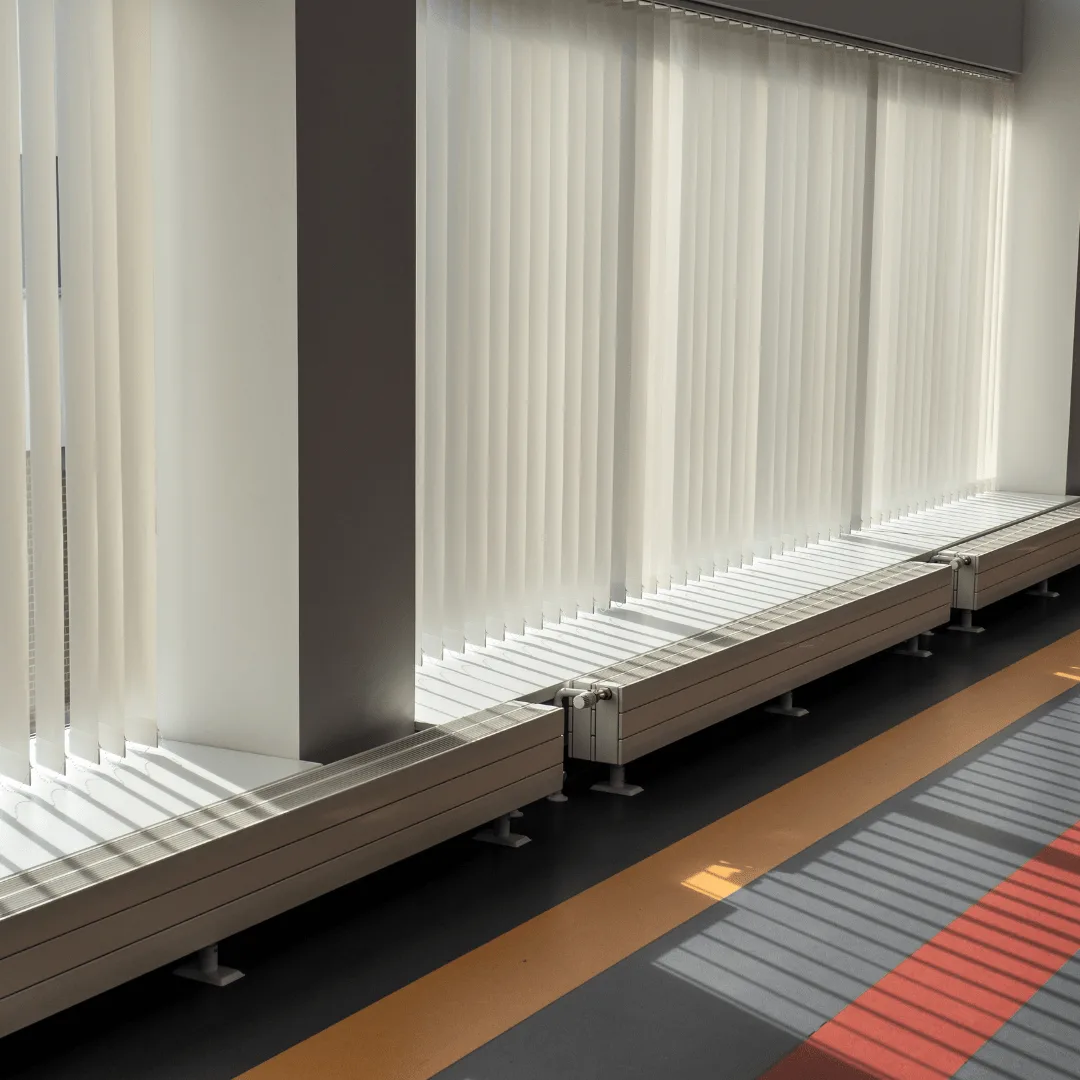 White vertical blinds across a wall of windows in an Orange County interior