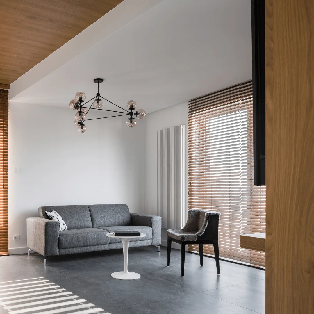 Real wood blinds framing windows in a modern Orange County living room