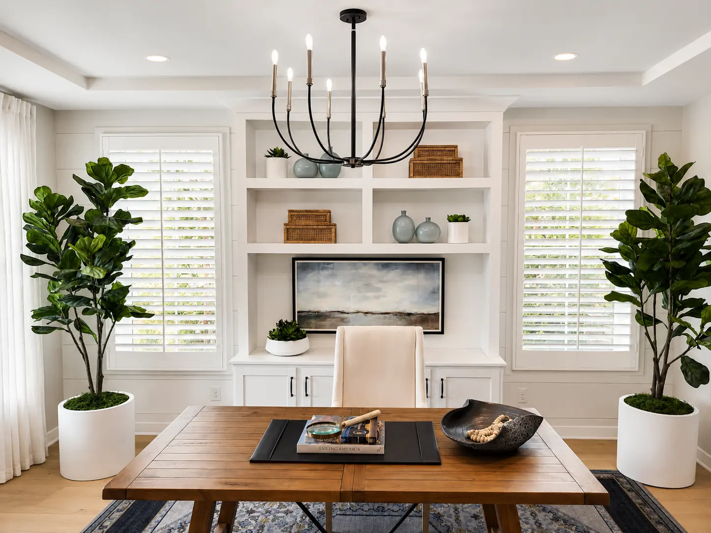 White plantation shutters in a modern coastal dining room