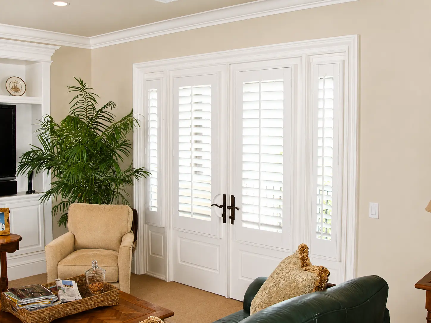 White plantation shutters on a French-door pair with side-light panels