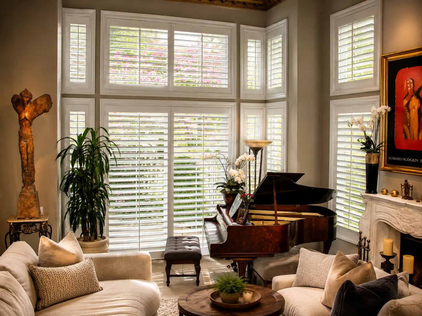 Stained basswood plantation shutters spanning a two-story window wall behind a grand piano
