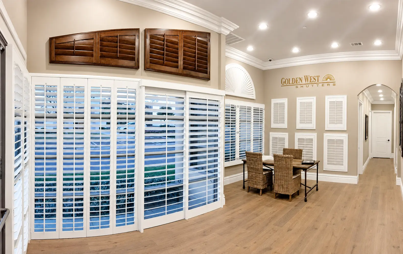 White bypass-track plantation shutters on a tall patio slider in a navy living room