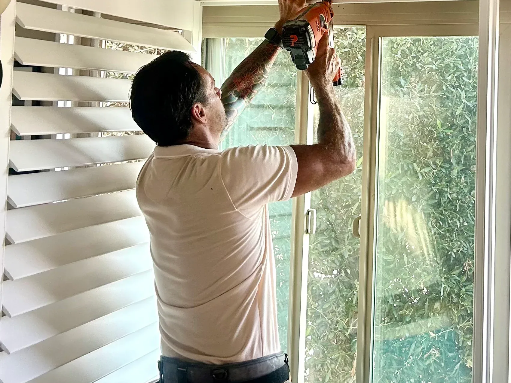 Golden West installer mounting plantation shutters in an Orange County home
