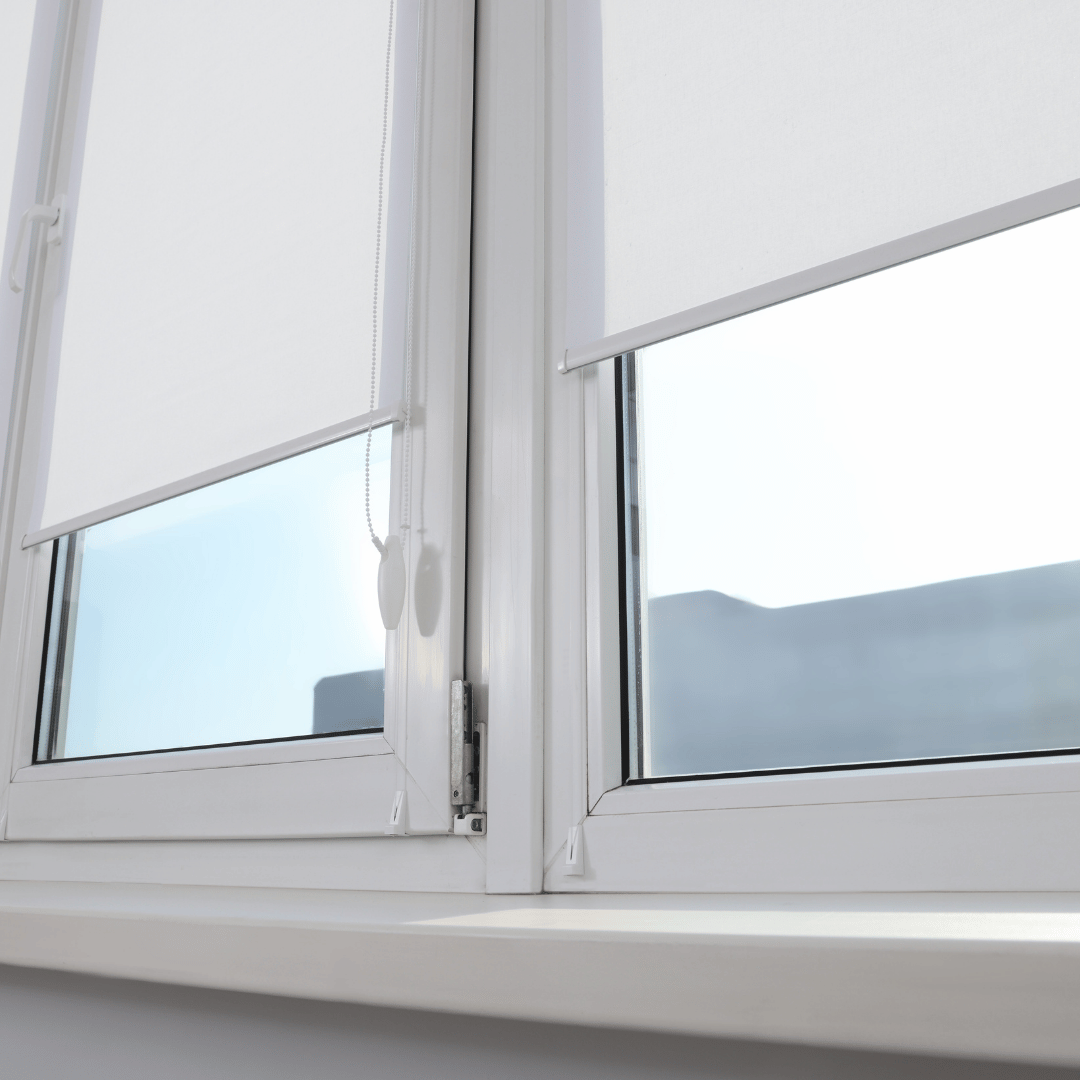 Light fabric roller-style shade lowered over a tilt-and-turn window